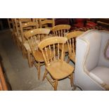 A set of four pine spindle back kitchen chairs