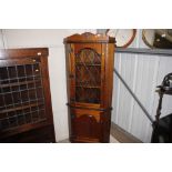 A thistle decorated carved corner cupboard