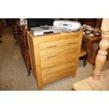 A modern lightwood chest of four drawers