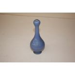 A small blue glazed onion topped vase