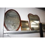 A mahogany shaped frame bevel edged wall mirror; a
