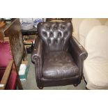 A faux leather buttoned deep seated easy chair