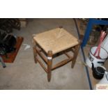 An elm and string seat stool