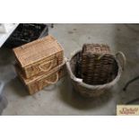 A wicker log basket, and three picnic baskets