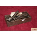 A wooden tray and contents of vintage secateurs, s