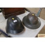 Two vintage tin helmets