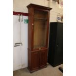 A late Victorian mahogany gun cabinet raised on a