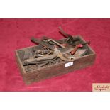A wooden box and contents of vintage secateurs