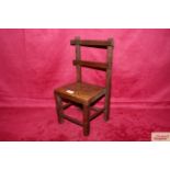 An early 19th Century carved oak miniature chair ,