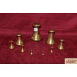 Nine graduated brass capstan shaped weights, ½oz -