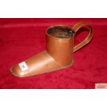An antique copper shoe shaped ale mull