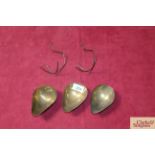 Three brass hanging scoops and two hangers