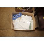 A box containing various linen and lace items, tab