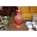 A faux red lacquer Oriental baluster table lamp