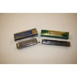 A boxed "The Bandmaster Deluxe Chromatic Harmonica";