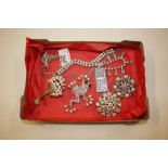 A box containing diamante brooches, necklaces etc