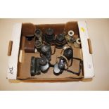 A box containing eight pairs of various binoculars