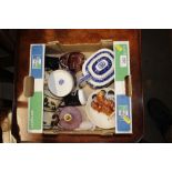 A box containing various decorative china to inclu