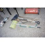 A quantity of long handled gardening tools, a saw