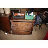 An antique oak chest fitted three long drawers