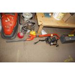 A Flymo long reach hedge trimmer with charger and