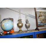 Two oil lamps with glass chimneys