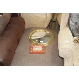 A brass framed circular wall mirror and one other