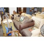 A modern leather upholstered three seat settee and