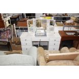 A modern dressing table with a triptych bevel edge