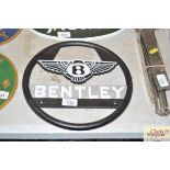 A cast metal Bentley style steering wheel sign