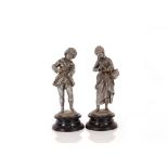 A pair of spelter figures, depicting a maid and youth AF, 32cm high