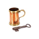 A Victorian antique copper and brass mounted quart mug, 18cm high; and a large antique iron key (2)