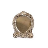 A late Victorian silver heart shaped easel mirror, by William Comyns, having pierced foliate
