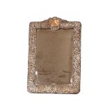 A large Edwardian silver mounted easel dressing table mirror, with profuse foliate scroll decoration