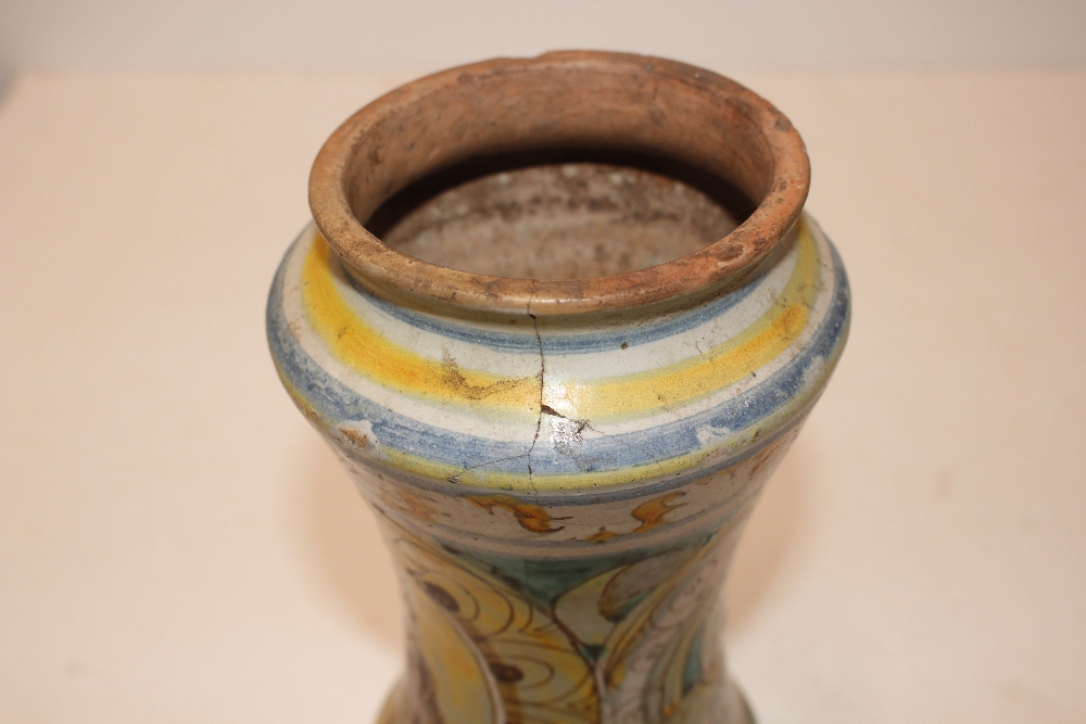 A glazed earthenware albarello, decorated with an oval panel of a priest surrounded by foliate - Image 3 of 8