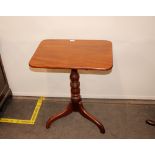 A 19th Century mahogany oblong snap top occasional table, raised on turned baluster column and