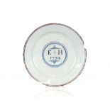 A rare Delftware blue and white plate, decorated with the initials "E" + "H" and dated 1738, 20cm