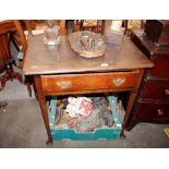 A George III oak side table, fitted with a single drawer raised on rounded tapering supports and pad