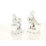 A pair of Meissen blanc de chine posy vases, in the form of children with baskets, having floral