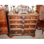 An 18th Century oak chest, fitted four long graduated moulded front drawers with brass drop