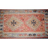A Caucasian or Anatolian Kelim rug, with two hooked medallions within powder blue lozenge and