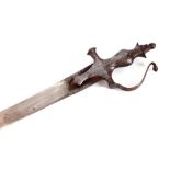 An antique Indian steel Tulwar sword, of typical form in a later wood and canvas scabbard 93cm
