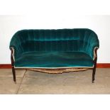 An Edwardian mahogany framed salon settee, upholstered in green buttoned Dralon, raised on