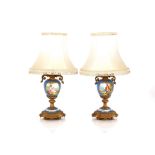 A pair of Sevres style porcelain and gilt metal mounted baluster table lamps, decorated rural scenes