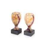 A pair of Blue John urns, of baluster form raised on black marble bases, 15cm high
