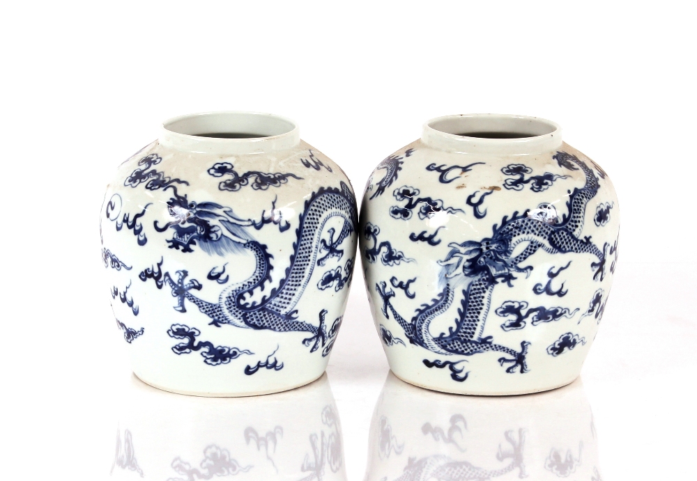 A pair of 19th Century Chinese blue and white porcelain jars, profusely decorated dragon, clouds and