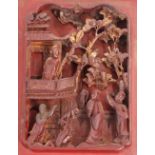 A 19th Century Chinese carved lacquered and gilt wood panel, decorated figures and foliage in