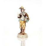 A Bourdois Bloch of porcelain figure, of a musketeer in brightly coloured livery on naturalistic