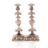 A pair of electroplated pass over candlesticks, 35cm high