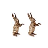 A pair of silver pepperettes, in the form of boxing hares